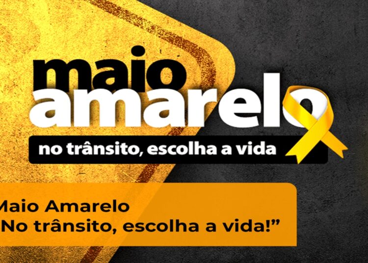 Campanha Maio Amarelo com laço amarelo e mensagem "No trânsito, escolha a vida" para conscientização sobre segurança no trânsito