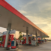 Posto de combustível vazio ao entardecer com bombas modernas.